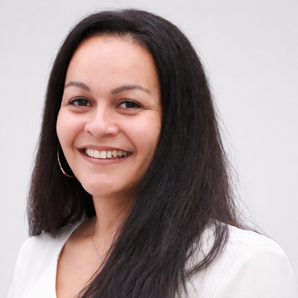 smiling latina woman in close up shot 1 - The Management Team